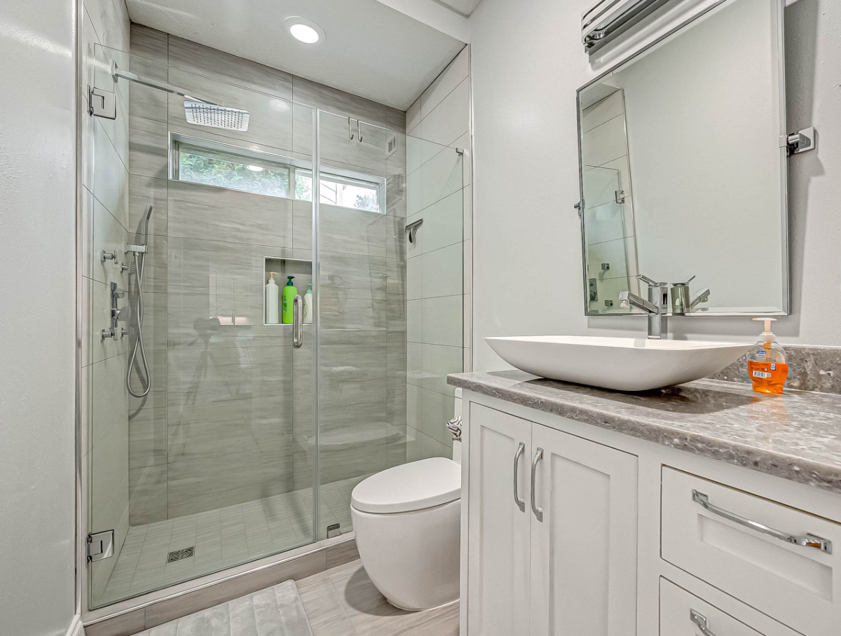 secondary bathroom with glass shower and modern vanity