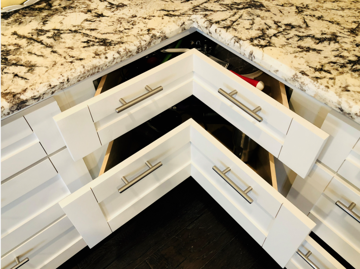 custom corner drawer storage beneath granite countertops in the remodeled kitchen