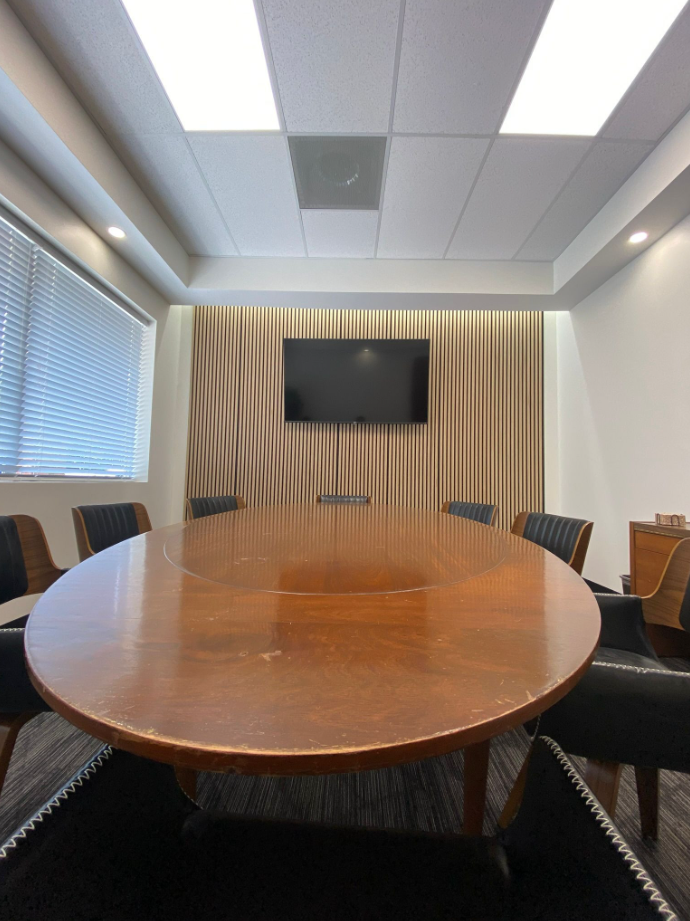 conference room front view with mounted display and acoustic paneling