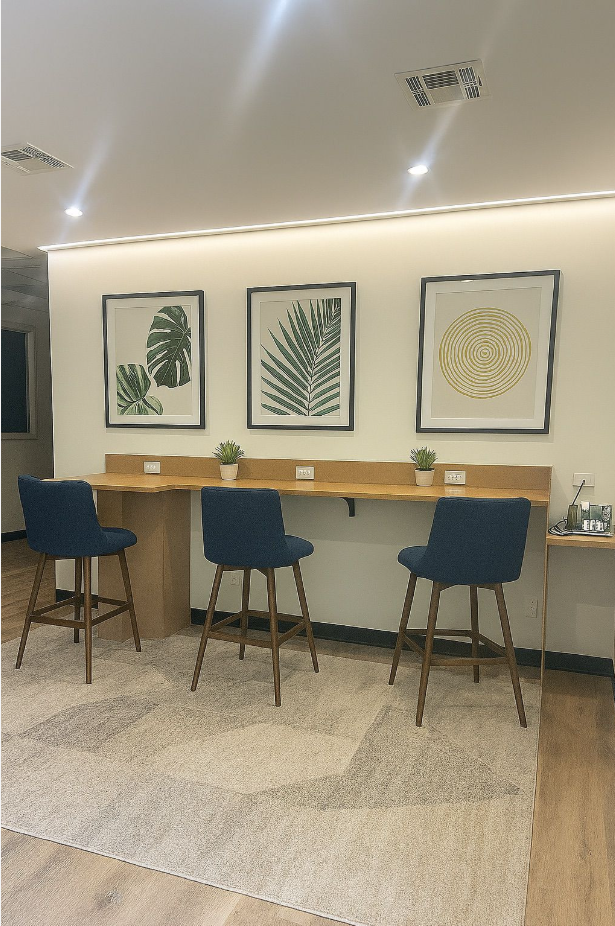 coworking counter with bar seating and framed botanical artwork